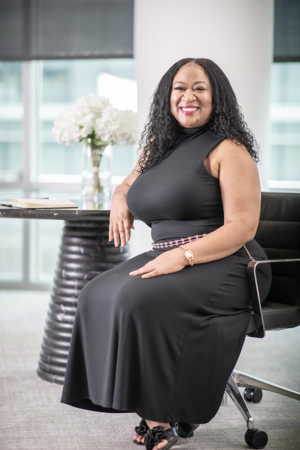 Tai Haynes, Senior Accounting Leader at GFF, seated in a modern Dallas workplace interior, photographed in a professional design firm setting.