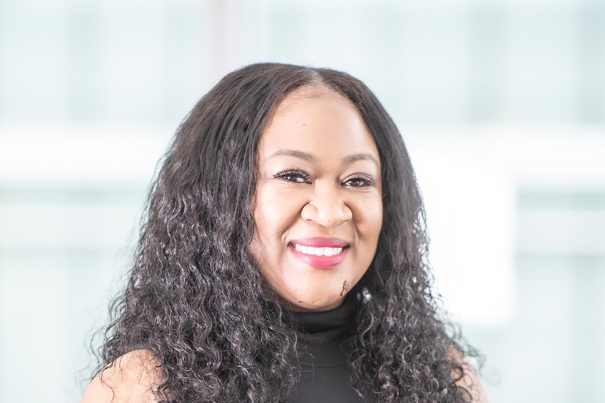 Tai Haynes, Senior Accounting Leader at GFF Dallas, close-up portrait in a bright modern workplace interior.